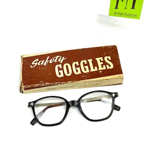 Vintage black safety glasses labeled Kendal with original Safety Goggles box.