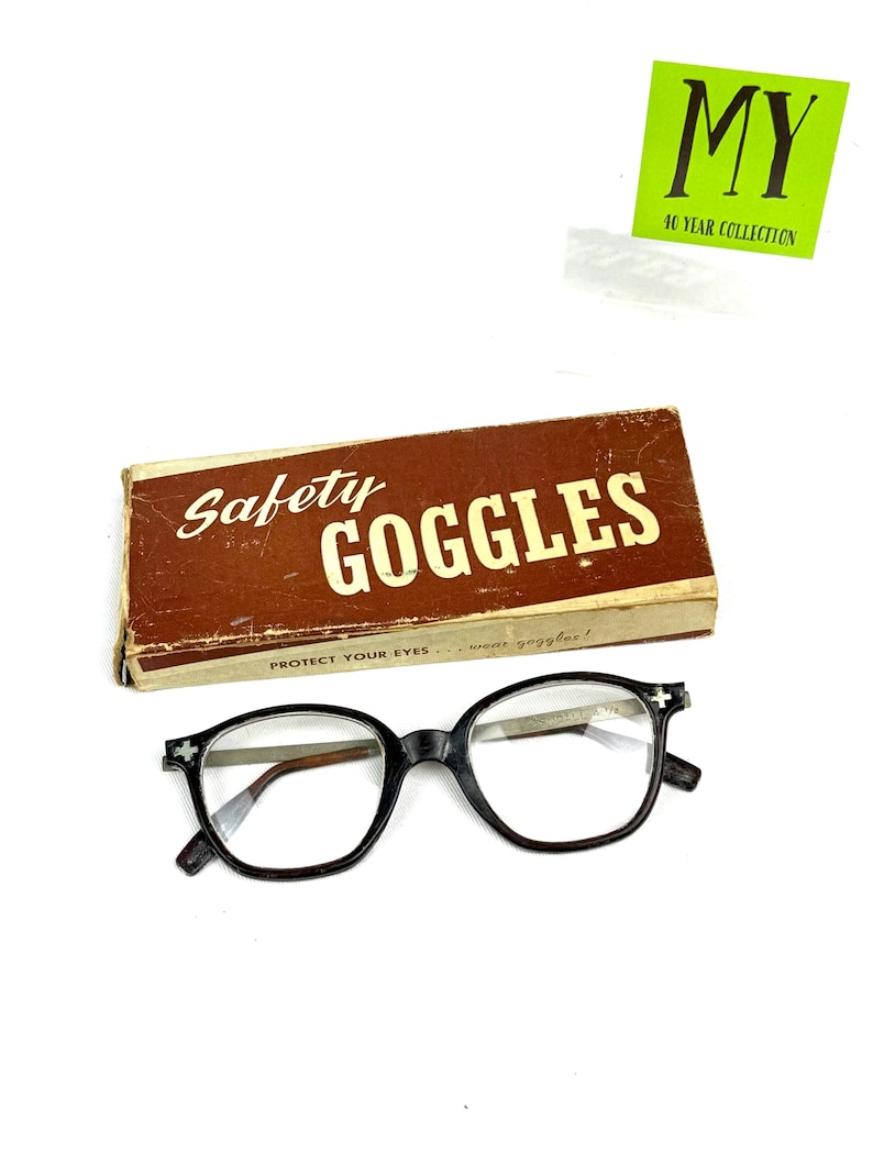 Vintage black safety glasses labeled Kendal with original Safety Goggles box.