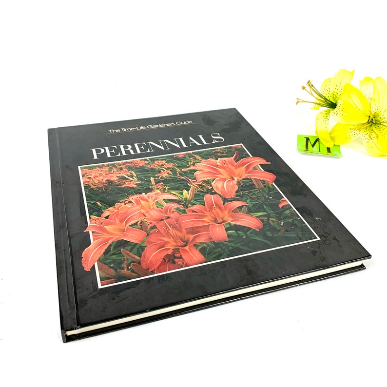 May include: A black hardcover book titled "The Time-Life Gardener's Guide: Perennials" with a photo of orange lilies on the cover.