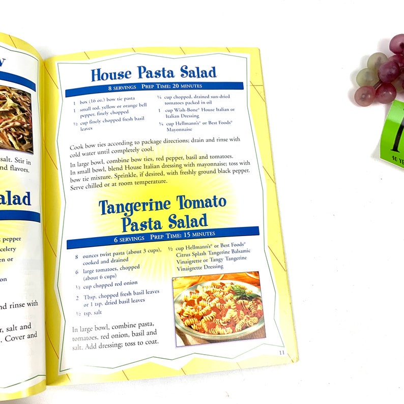 May include: A recipe for House Pasta Salad and Tangerine Tomato Pasta Salad. The recipe includes ingredients and instructions for both salads. The image shows a close-up of the recipe text and a photo of the Tangerine Tomato Pasta Salad.