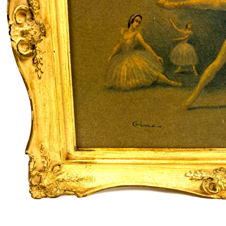 May include: A framed painting of three ballerinas in a soft, muted color palette. The ballerinas are wearing white tutus and are posed in a graceful dance. The painting is signed "Gino" in the bottom right corner.