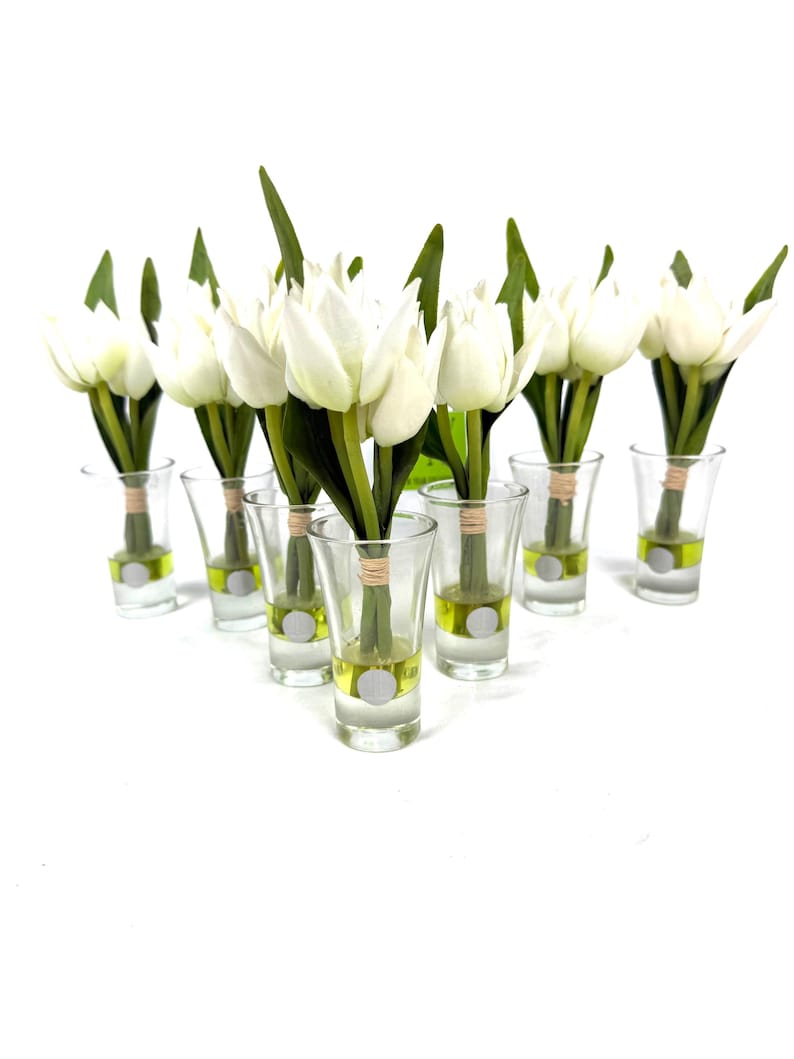 Set of 7 white faux tulip flower arrangements in L Collection glass vases with faux water and twine accents.