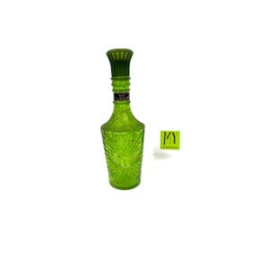 May include: A green glass bottle with a textured, starburst design. The bottle has a tall, fluted neck and a matching green stopper. A small label is visible on the neck. The bottle is empty and sits on a white background.
