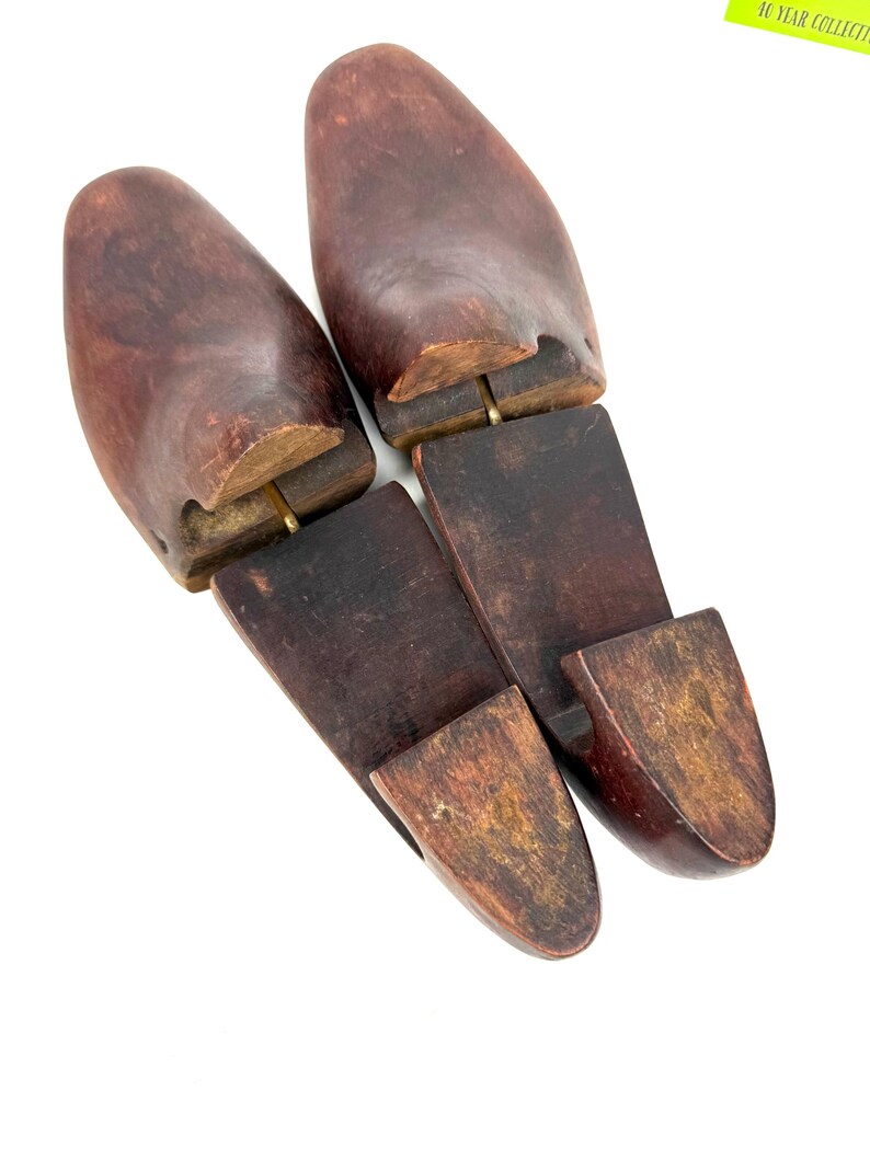 Pair of vintage wooden shoe stretchers angled with rich patina