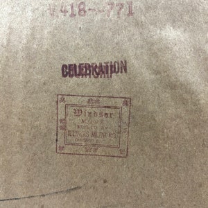 May include: A close-up of a brown paper tag with the text "CELEBRATION" and "Windsor Model Styled by Illinois Mfg. Co. Chicago, Ill."