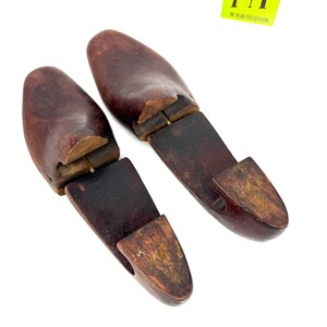 Pair of vintage wooden shoe stretchers angled with rich patina