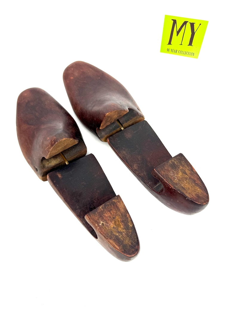Pair of vintage wooden shoe stretchers angled with rich patina