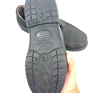 May include: Black leather shoes with a textured rubber sole. The sole features the brand name "VALLEVERDE" and other text. The shoes are designed for comfort and durability, suitable for everyday wear.