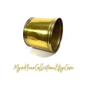 May include: A cylindrical brass planter with a hammered texture. The planter is a bright gold colour and has a rolled rim. The Etsy shop name "My4YearCollection.Etsy.Com" is written in gold script at the bottom.