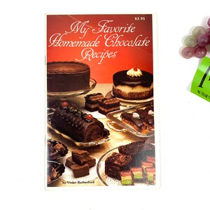 May include: A cookbook titled "My Favorite Homemade Chocolate Recipes" by Violet Rutherford. The cover features a variety of chocolate desserts, including cakes, pastries, and truffles.