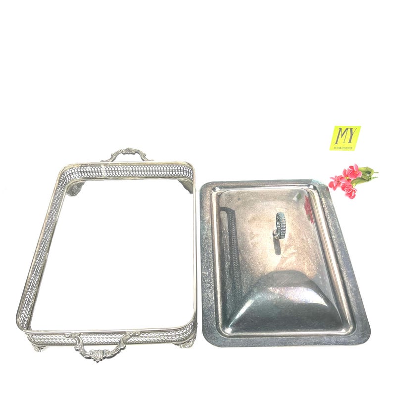 May include: Silver serving dish with a lid. The dish has a decorative border and a handle on the lid.