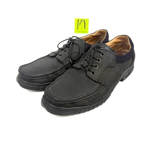 May include: Pair of black leather lace-up shoes. The shoes have a rounded toe, a thick sole, and a padded collar. The laces are black, and the interior is a light brown color. The shoes are displayed on a white background.