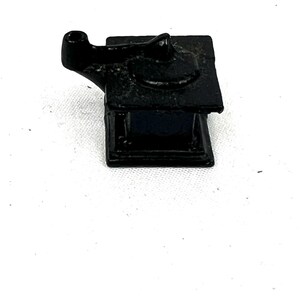 May include: A black cast iron coffee grinder with a crank handle.