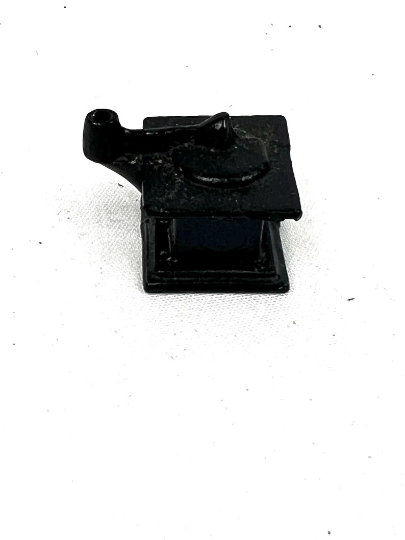 May include: A black cast iron coffee grinder with a crank handle.