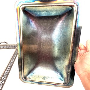 May include: Silver serving tray with a decorative, openwork design. The tray has a matching lid with a smooth, slightly concave interior.