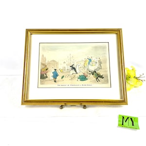 Peut inclure: Une estampe ancienne encadrée représentant une scène humoristique d'une calèche tirée par un cheval aveugle, avec des gens qui tombent et s'enfuient. L'estampe est intitulée "The Result of Purchasing a Blind Horse."