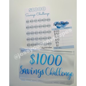 May include: A clear vinyl savings envelope and two matching cards with blue text. The envelope and one card read "$1000 Savings Challenge." The second card is a "Cash Breakdown" sheet for tracking bills.