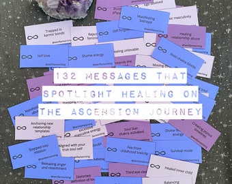 May include: An assortment of purple and blue cards with text, arranged around a cluster of amethyst crystals. The cards feature phrases like "Self love" and "Healing relationship abuse." The central text reads "132 MESSAGES THAT SPOTLIGHT HEALING ON THE ASCENSION JOURNEY."
