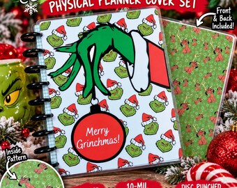 May include: A physical planner cover set featuring a green character wearing a Santa hat, holding a red ornament with the text Merry Grinchmas. The set includes a back cover with a green pattern of a brown dog with antlers and a red nose.