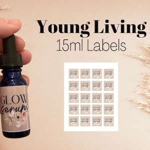 Op de afbeelding: Een donkerblauwe glazen fles met een druppelaar, met het label "GLOW Serum" met bloemmotieven. De afbeelding toont ook een vel met kleine vierkante labels met de tekst "GLOW Serum" en "Young Living 15ml Labels".