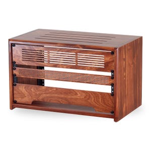 May include: A rectangular wooden rack enclosure with a rich brown finish. The top features parallel ventilation slots. The front panel includes a horizontal slatted vent, a perforated metal strip, and a solid wooden base section with black hardware.