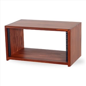 May include: A rectangular, wooden audio rack in a warm reddish-brown hue. The rack features an open front and back, with black metal rails on the sides for mounting equipment. The wood grain is visible, adding texture to the design.
