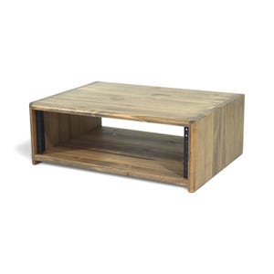 May include: A rectangular wooden audio rack with a natural finish. The rack has an open front and back, with a shelf in the middle. Black metal rails are visible on the sides, designed for mounting audio equipment. The wood grain is visible.