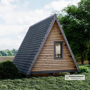 May include: A small, wooden, A-frame cabin with a gray shingled roof. The cabin has a single window and a wooden door. The cabin is surrounded by green grass and trees.
