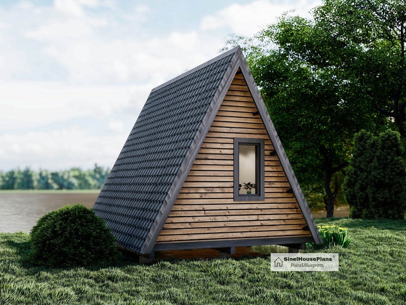 May include: A small, wooden, A-frame cabin with a gray shingled roof. The cabin has a single window and a wooden door. The cabin is surrounded by green grass and trees.