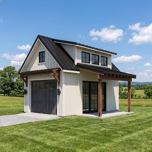 May include: A two-storey, cream-coloured building with a black metal roof and dark grey garage door. The building has a small porch with wooden supports and black-framed windows. Set on a green lawn under a blue sky.