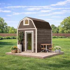 May include: A small, brown wooden shed with a dark brown roof, white trim, and a small window. The shed has a glass door and sits on a wooden deck. A small table and chairs are set up outside.