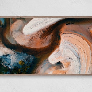 May include: Abstract aerial photograph of a landscape with swirling patterns of white, orange, and brown sand.