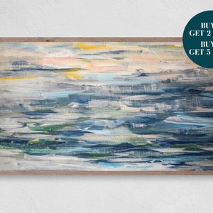 May include: Abstract painting in shades of blue, green, white, and yellow. The painting is framed in a light wood frame.