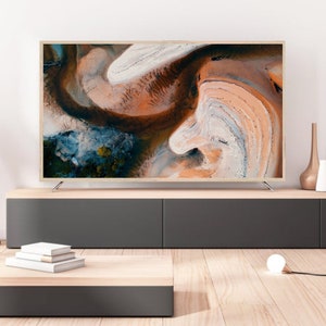 May include: A modern living room interior with a flat screen TV on a dark grey entertainment center. The TV is displaying an abstract image of swirling colors. There are decorative vases and a lamp on the shelf above the entertainment center.