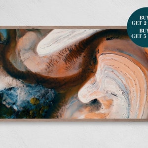 May include: An abstract aerial photograph of a landscape with swirling patterns of orange, brown, white, and blue. The image is framed in a wooden frame.