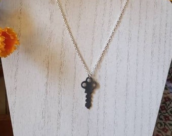Antique fancy skeleton key on a silver chain with silver hardware