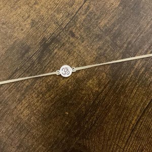 Silver Om rakhi pale yellow / Raksha Bandhan