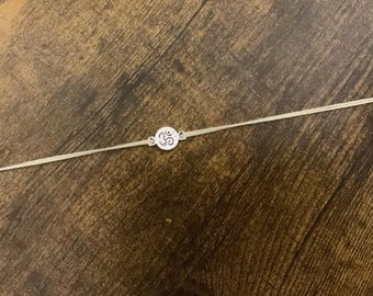 Silver Om rakhi pale yellow / Raksha Bandhan