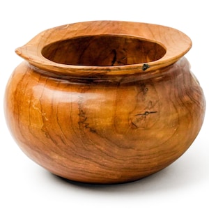 May include: A large, round wooden bowl with a wide, flared rim. The bowl is made of light brown wood with a smooth, polished finish.