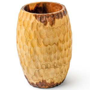 May include: A wooden bowl with a textured, carved surface. The bowl is light brown with darker brown accents.