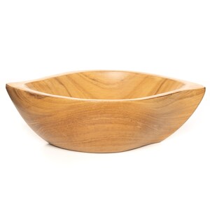 May include: A natural wood bowl with a rounded, oval shape. The bowl is made of light brown wood with a smooth, polished finish.