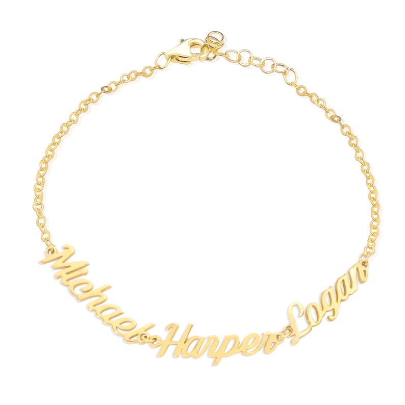 May include: Gold chain bracelet with the names "Michael", "Harper", and "Logan" written in cursive.