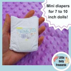 May include: A white diaper with a blue and yellow design featuring a cartoon elephant and the text "Pampers" and "I love you". The diaper is small enough to fit a 7 to 10 inch doll.