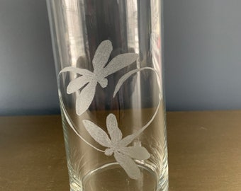 This stunning hand etched piece boasts 2 dragonflies bonded by love. This vase is versitile and can also be used as a pillar candle holder.