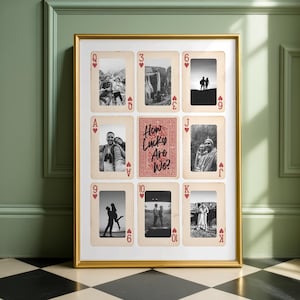 May include: A framed wall art piece featuring playing card designs with black and white photographs. The central card reads "How Lucky Are We?" in a decorative font. The frame is gold.