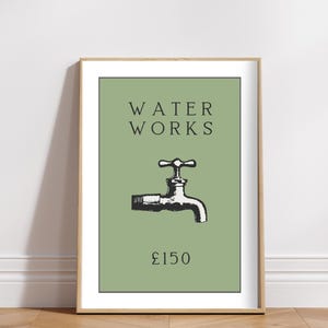 May include: A framed wall art print featuring a sage green background with the black text WATER WORKS centered at the top. Below the text is a black and white illustration of a water faucet, with the black text &pound;150 positioned at the bottom.