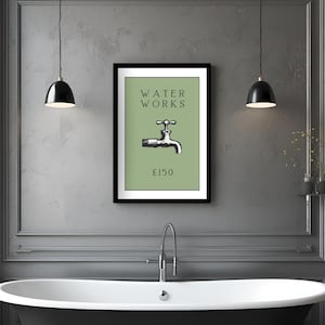 May include: A framed wall art print featuring a sage green background with the black text WATER WORKS above a black and white illustration of a water faucet and the text &pound;150 below, all enclosed within a simple black rectangular frame.