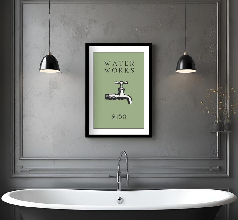 May include: A framed wall art print featuring a sage green background with the black text WATER WORKS above a black and white illustration of a water faucet and the text &pound;150 below, all enclosed within a simple black rectangular frame.
