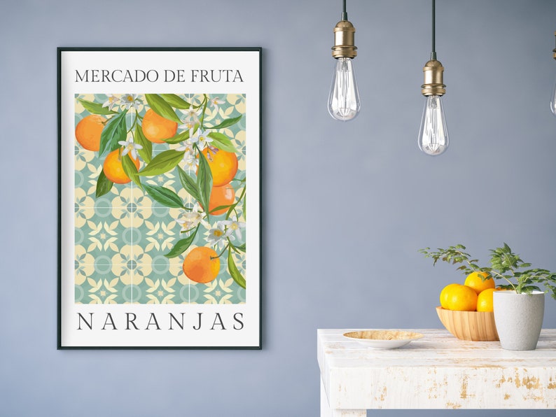 May include: A framed print with a blue and white tiled background featuring a branch of orange blossoms and oranges. The text "MERCADO DE FRUTA" and "NARANJAS" is printed in black at the top and bottom of the print.