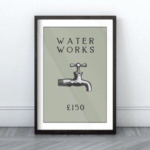 May include: A framed wall art print featuring a sage green background with the black text WATER WORKS at the top, a black and white illustration of a water faucet in the center, and the text &pound;150 printed in black at the bottom of the design.